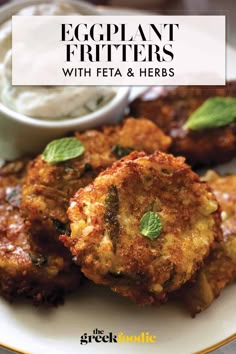 eggplant fritters with feta and herbs on a plate next to dip