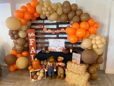 an arch made out of balloons and hay bales is displayed in the center of a room