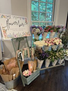 flowers are arranged on display in front of a sign