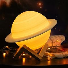 the solar system lamp is sitting on top of a table