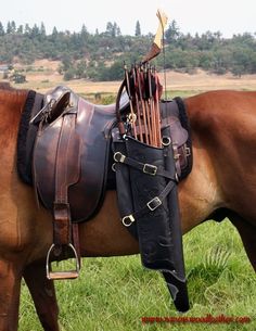 a brown horse standing on top of a lush green field