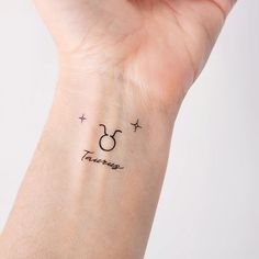 a small wrist tattoo with the word disney written on it