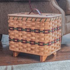 a woven basket sitting on top of a wooden table next to a couch and chair