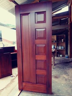 an open wooden door in the middle of a room