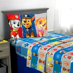 a bed with paw patrol sheets and pillow cases