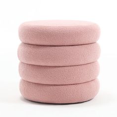 four pink round cushions stacked on top of each other