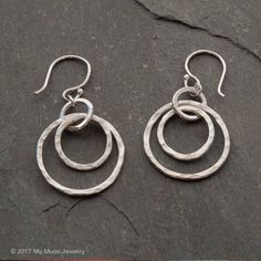 "These sterling silver double hoop dangle earrings are just slightly different from ordinary. They are handmade from 16 gauge argentium silver wire and 21 gauge ear wires, they hang about an 1\" 5/8 long including the hand made ear wire, 1\" from bottom of earwire. They are completely hand made and organic in nature. Your can choose between a sterling silver french earlier (pictured) or a sterling silver lever back earwire. Hypo-allergenic Niobium french earwires (dark gray color) also are avail Hammered Copper Earrings, Hammered Silver Jewelry, Jewelry Rustic, Half Moon Earrings, Silver Jewelry Diy, Circle Jewelry, Rustic Earrings, Double Hoop Earrings, Earrings Circle