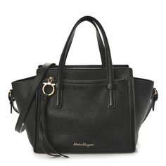 This is an authentic SALVATORE FERRAGAMO Hammered Calfskin Double Handle Small Amy Tote in Black. This chic small shoulder bag is finely crafted of hammered black calfskin leather. The bag features a front zipper pocket, looping leather handles, and a removable shoulder strap. The top is open to a black leather interior with a zipper pocket. Studio Bag, Denim Quilt, Small Shoulder Bag, Leather Handles, Flap Bag, Leather Interior, Blue Bags, White Bag, Leather Handle