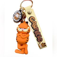 an orange key chain with a cartoon character on it's front and back ends