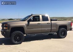 a silver truck parked in a parking lot