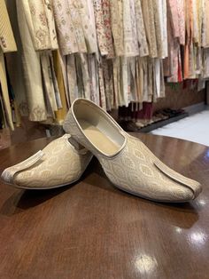 pair of slippers sitting on top of a wooden table