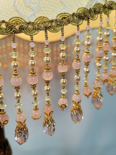 a chandelier with pink and gold beads hanging from it