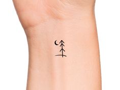 a small wrist tattoo with an arrow on it