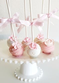 three cake pops with pink and white frosting