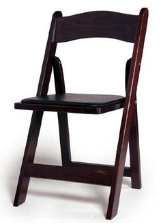 a wooden folding chair sitting on top of a white floor