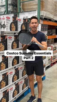 a man holding a frying pan in front of a stack of boxes with the words costco summer essentials part 2