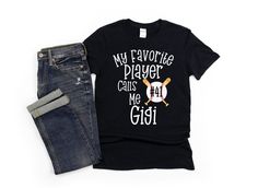 Cute Customized Gigi baseball Tshirt to wear on game day to show your pride for grandson or granddaughter on the school baseball team or travelling team. Perfect personalized gift for Gigi to wear to support their loved one that is out on the field. Fun way to show your love for your favorite baseball or softball player in the family. A comfy and cute custom shirt to wear all season long. Gildan unisex and Bella Canvas unisex shirts are used depending on the color of shirt picked. Please specify Gigi Shirts, Baseball Tshirt, Softball Players, Baseball Gifts, Baseball Game, Gaming Shirt, Baseball Games, Custom Shirt, Baseball Team