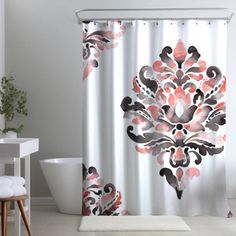 a bathroom with a shower curtain and rug