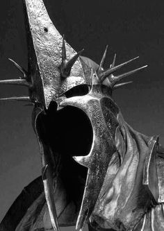 black and white photograph of a knight's helmet with spikes sticking out from it