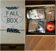 an open box with cookies, marshmallows, and an apple inside it