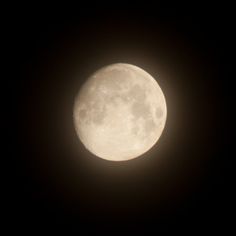 the full moon is seen in the dark sky