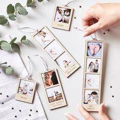 someone is holding four photos in their hand and hanging them on the table with greenery