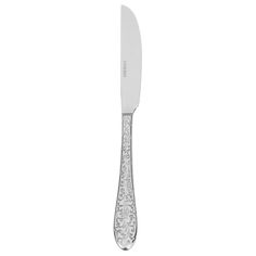 a knife that is sitting on top of a white tablecloth with an intricate design