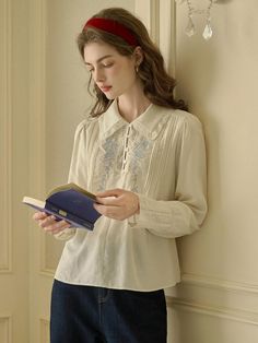 This Rose Embroidery Shirt exudes vintage charm, featuring intricate embroidery on the front that brings a touch of elegance to the classic silhouette. Its soft collar and button-down design make it a versatile piece that pairs well with both formal and casual attire. Delicate lace detailing along the cuffs and collar adds a sophisticated and timeless finish. - Crafted with attention to detail, the shirt includes pin-tuck accents along the front panel.- The back of the shirt is kept simple, ensuring the focus remains on the beautiful embroidery work.- It's designed with long sleeves and buttoned cuffs, offering a tailored and comfortable fit.- Made from a breathable fabric, it is ideal for both cool and warm weather, transitioning effortlessly between seasons. Asian Style Clothes, Embroidery Shirt, Blouse Sale, Simple Blouse, Rose Embroidery, Lace Patchwork, Shirt Embroidery, Classy Casual, Casual Attire