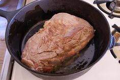 a piece of meat is being cooked in a skillet