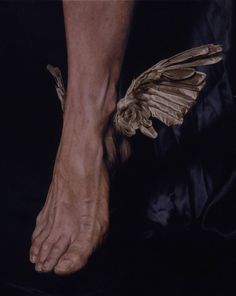 a close up of a person's foot with a bird on it