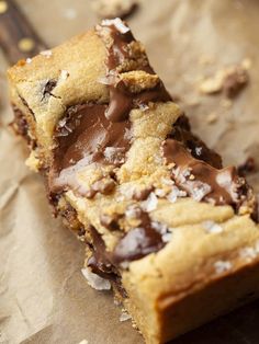 chocolate chip cookie bars are stacked on top of each other with one bite taken out