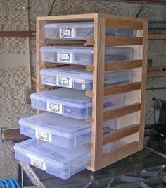 several plastic containers stacked on top of each other in a storage unit with wooden shelves