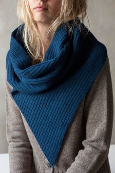 a woman with blonde hair wearing a blue scarf