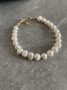 Handcrafted by IJ Design Boutique Made in Uk Made of: * Genuine Baroque pearls 9-10 mm * 18k gold plated details Bracelet circumference adjustable 16.5cm - 20cm / 6.5-7.9 Inches  Closure: Lobster clasps  -IJ DESIGN BOUTIQUE- From necklaces to earrings, we make jewellery using a wide range of materials. From silver and gold plated to freshwater pearls and real gemstones.  Our collections are all based on the latest trends in jewellery along with classic pieces which won't date. You are able to la Elegant Baroque Pearl Beaded Bracelets As Gifts, Luxury White Baroque Pearl Bracelets, Classic Baroque Pearl Bracelet For Formal Occasions, Classic Baroque Pearl Bracelets With Oyster Detail, Classic Baroque Pearl Bracelets With Oyster Clasp, Classic Baroque Pearl Bracelets, Classic Baroque Pearl Bracelet With Pearl Drop, Luxury Baroque Pearl Bracelet As Gift, Luxury Baroque Pearl Bracelet For Gift