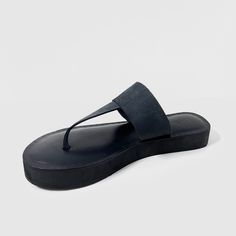 The Katherine Black leather designer flip flop thong sandal combines style and comfort with its mid eva sole cushioning. These sandals provide excellent support for all-day wear. Expert craftsmanship and high-quality leather make this a must-have addition to your summer wardrobe. Features: Slip-on design Cushioned mid eva sock Embossed sock design for elegant look Traditional Thong upper design Composition: Upper - 100% Leather Lining - 100% Leather Sock - 100% Leather Outsole - 100% Rubber Modern Leather Toe Ring Sandals For Beach, Modern Leather Footbed Open Toe Flip Flops, Modern Leather Footbed Flip Flops, Modern Leather Beach Slippers, Cushioned Toe Post T-strap Sandals, Synthetic T-strap Toe Post Sandals With Cushioned Footbed, Synthetic Toe Post T-strap Sandals With Cushioned Footbed, Modern T-strap Sandals With Cushioned Footbed, Leather Toe Post Footbed Sandals