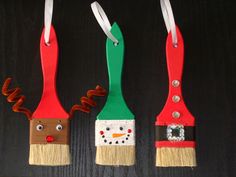 three christmas decorations made out of toothpicks and paintbrushes with faces on them