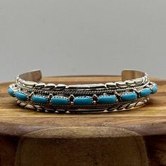 This beautiful Navajo cuff style bracelet features sterling silver and lovely blue turquoise stones. This turquoise bracelet has a vintage feel and is a nice size measuring 5.5" in diameter end to end with a 1.75" gap making it the perfect size for larger wrists. It is 1/2" wide making it very comfortable and easy to wear every day.  Cuff can be adjusted inward or outward to fit most wrist sizes. These cuff bracelets work equally as well for men as for women.  They would make a wonderful gift fo Bohemian Sterling Silver Turquoise Bracelet, Southwestern Style Sterling Silver Bracelet, Southwestern Blue Sterling Silver Bracelet As A Gift, Blue Southwestern Sterling Silver Bracelet Gift, Southwestern Blue Sterling Silver Bracelet Gift, Southwestern Style Blue Sterling Silver Bracelet Gift, Bohemian Blue Sterling Silver Bangle, Southwestern Blue Sterling Silver Bangle Bracelet, Southwestern Blue Sterling Silver Bangle