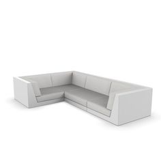 a white couch sitting on top of a white floor