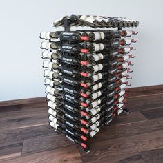 a stack of wine bottles sitting on top of a wooden floor