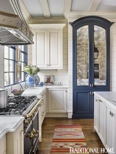 a kitchen with white cabinets and blue trim on the doors is pictured in this image