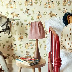 a child's bedroom with wallpaper and horse head