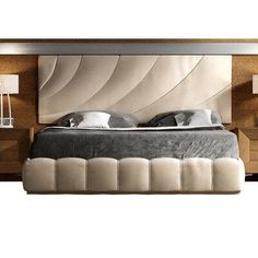 a large bed sitting in the middle of a bedroom next to two nightstands and lamps