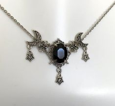 This is a new handmade necklace. It is made with antiqued silver plated filigrees, accented with a high quality JET BLACK glass rhinestone. Decorated portion is 2 1/2" wide and 1 3/4" tall in the center. Necklace is adjustable 15-18" with a lobster clasp and chain extender. If you would like a different length, please send us a message. Black Engraved Jewelry For Halloween, Engraved Black Jewelry For Halloween, Gothic Silver Crescent Necklace, Gothic Crescent Silver Necklace, Gothic Antique Silver Nickel-free Jewelry, Nickel-free Antique Silver Gothic Jewelry, Black Engraved Necklace For Halloween, Black Engraved Necklace For Wedding, Gothic Engraved Adjustable Necklace