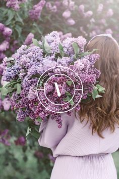 a woman holding a bunch of flowers in front of her face with the time on it