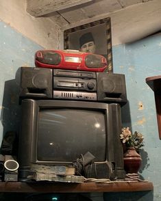 an old tv sitting on top of a shelf