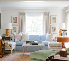 a living room filled with lots of furniture next to a fire place mantle and window