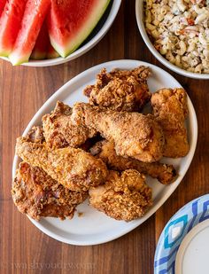 fried chicken, watermelon and rice on a table