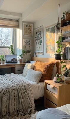 a bed room with a neatly made bed and lots of plants on the windowsill