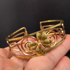 *Description: This is a beautiful 14 K rolled gold overlay Krementz cuff bracelet featuring a gold four leaf clover in the center. The open work makes the bracelet light on your wrist. On the end of each side of the cuff is the KREMENTZ stamp. I acid tested the surface of the bracelet which tested at 14K gold. The inside is a magnetic unknown metal. The bracelet is six inches around the inside with 3/4 of an inch gap. This cuff bracelet would be a great gift or wonderful addition to your vintage Antique Gold Cuff Bracelet For Anniversary, Unique Gold Cuff Bracelet For Collectors, Victorian Gold Cuff Bracelet For Anniversary, Vintage Yellow Gold Cuff Bracelet For Anniversary, Heirloom Gold Cuff Bracelet Gift, Yellow Gold Wedding Bracelet, Formal Yellow Gold Brass Cuff Bracelet, Retro Gold Cuff Bracelet As A Gift, Yellow Gold Brass Cuff Bracelet For Weddings