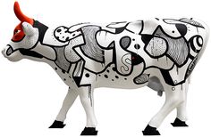 a white cow with black and red designs painted on it's body, standing in front of a white background